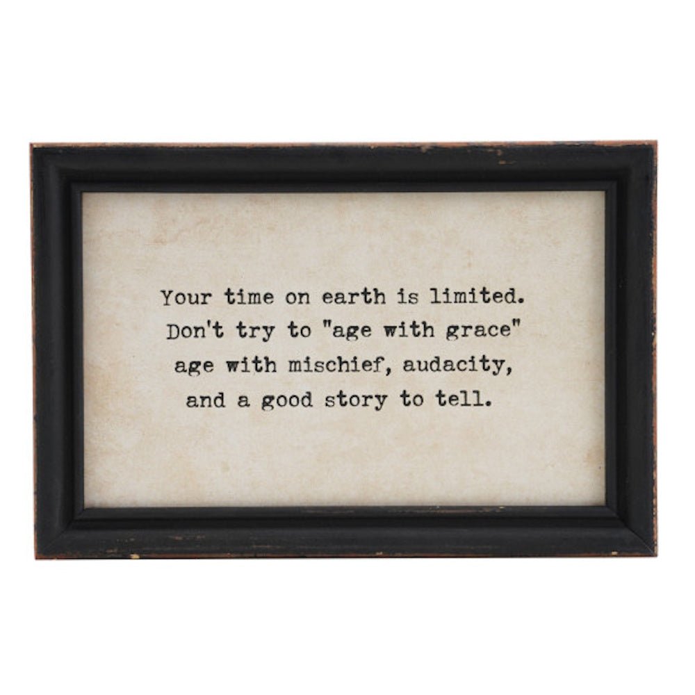 A framed wall decor quote about aging with mischief, audacity, and a good story to tell.