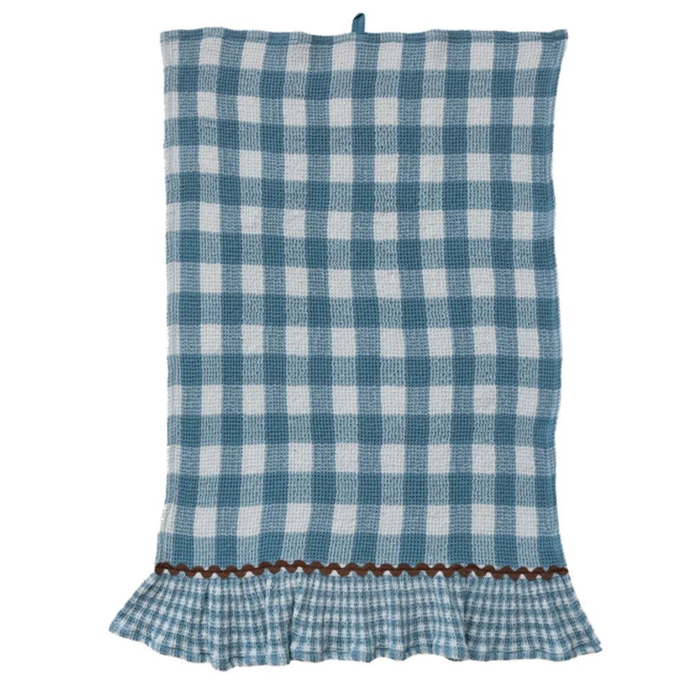 Blue and white buffalo check waffle-weave kitchen towel featuring a brown ric-rac trim and ruffled hem.
