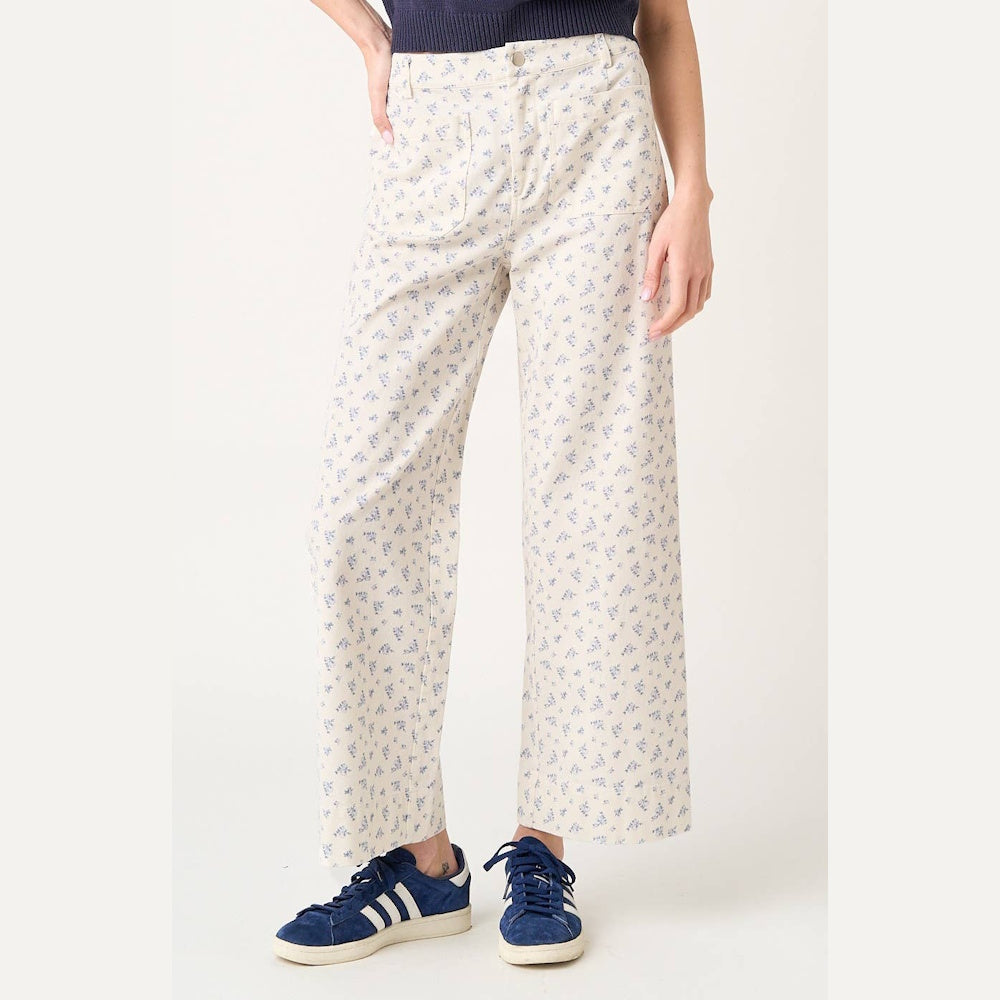 Women's cream wide-leg pants featuring a blue ditsy floral print, high waist, and utility pockets.