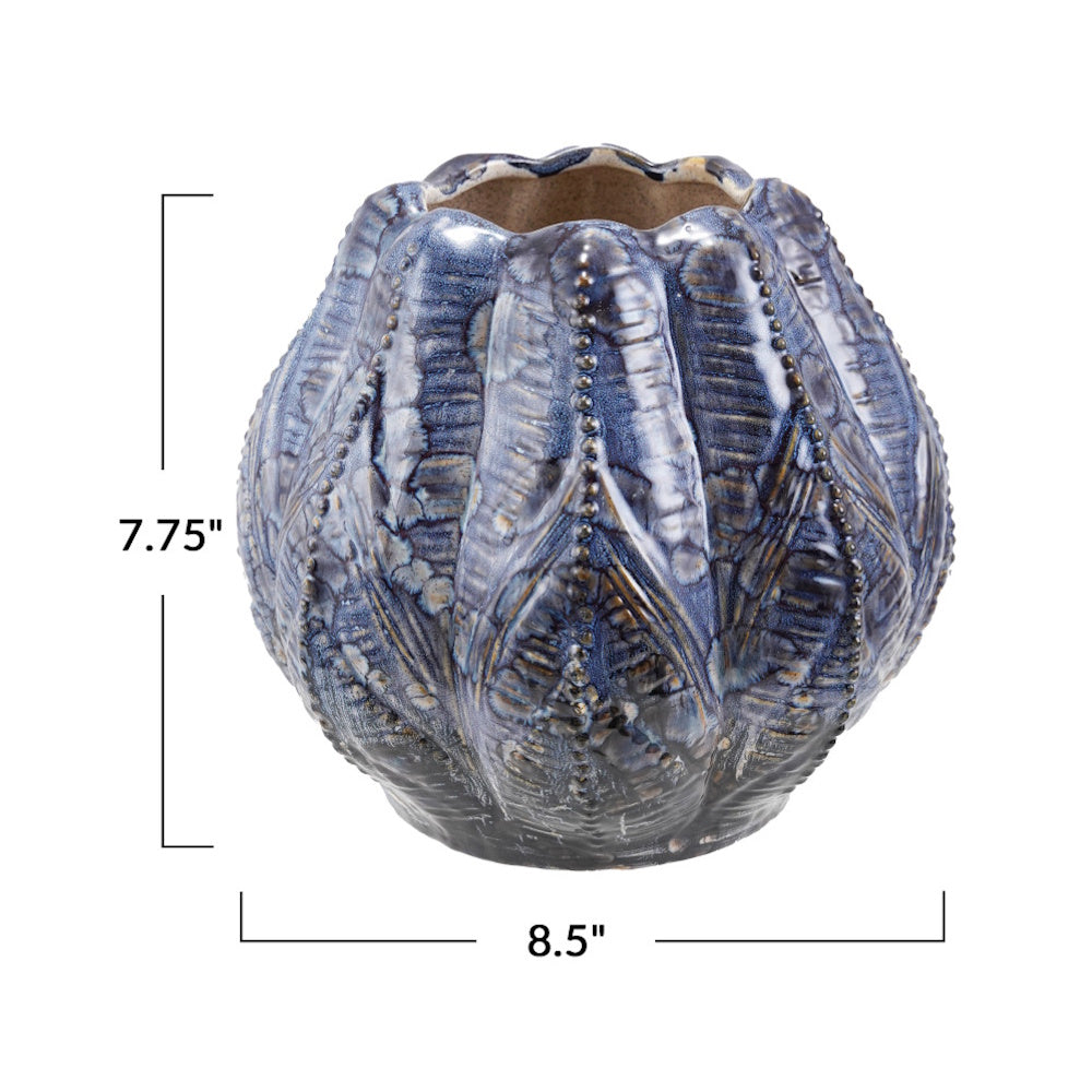 Blue embossed stoneware planter with dimensions: 7.75" height and 8.5" width.