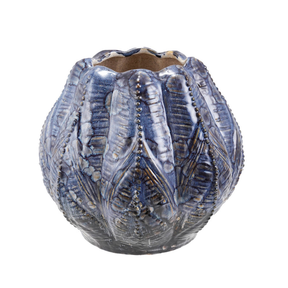A textured blue ceramic planter with embossed ribbed details and a glossy mottled glaze.
