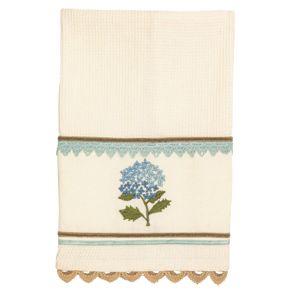 Cream waffle-knit hand towel with blue hydrangea embroidery, light blue lace trim, and tan scalloped edges.