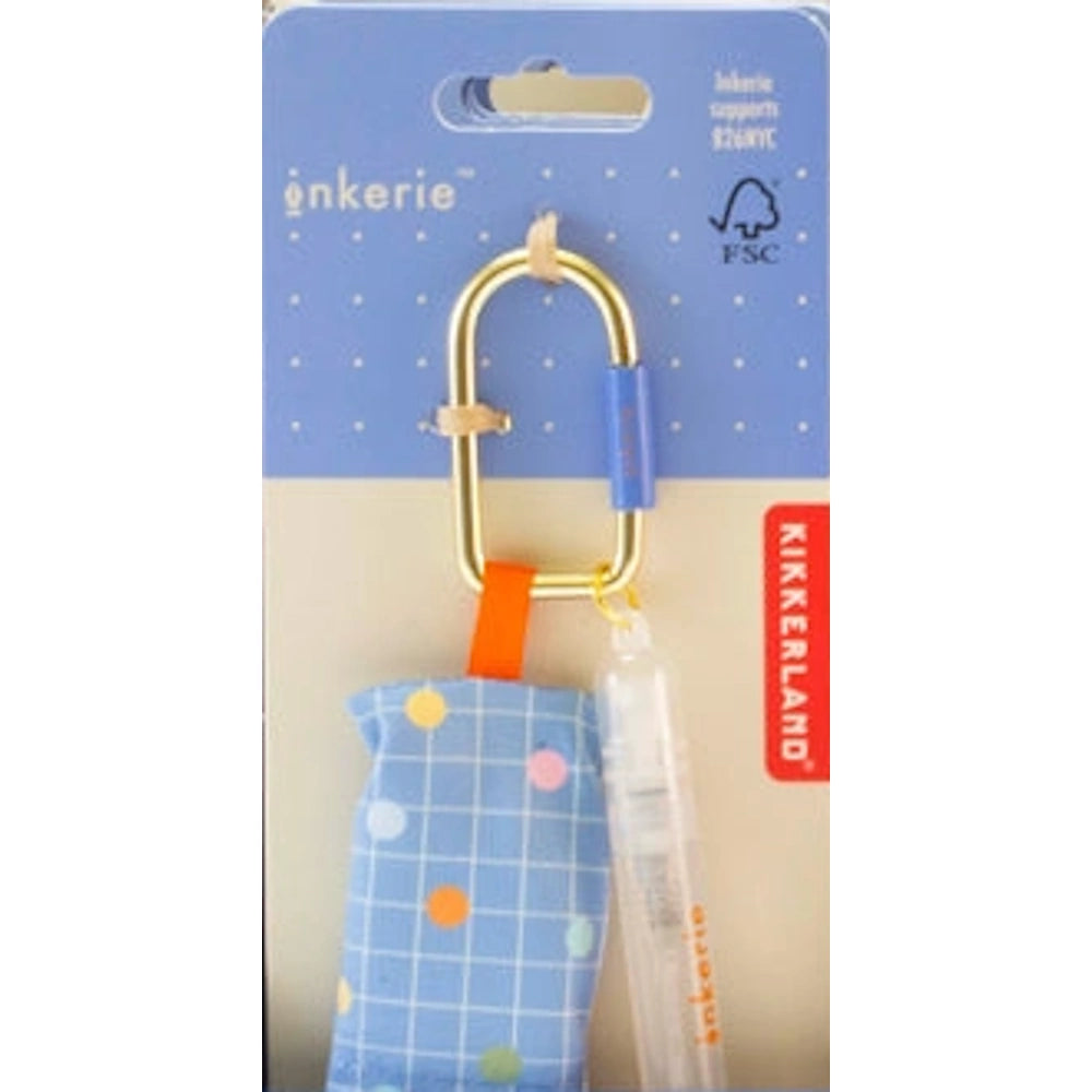 Inkerie on-the-go lens and screen cleaning kit with a blue patterned cloth and spray bottle on a gold carabiner.