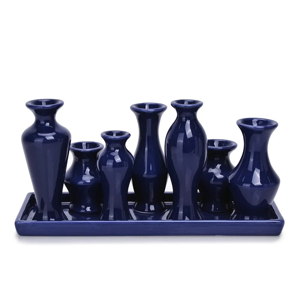 Blue ceramic bud vase set arranged on a matching tray from a front view.