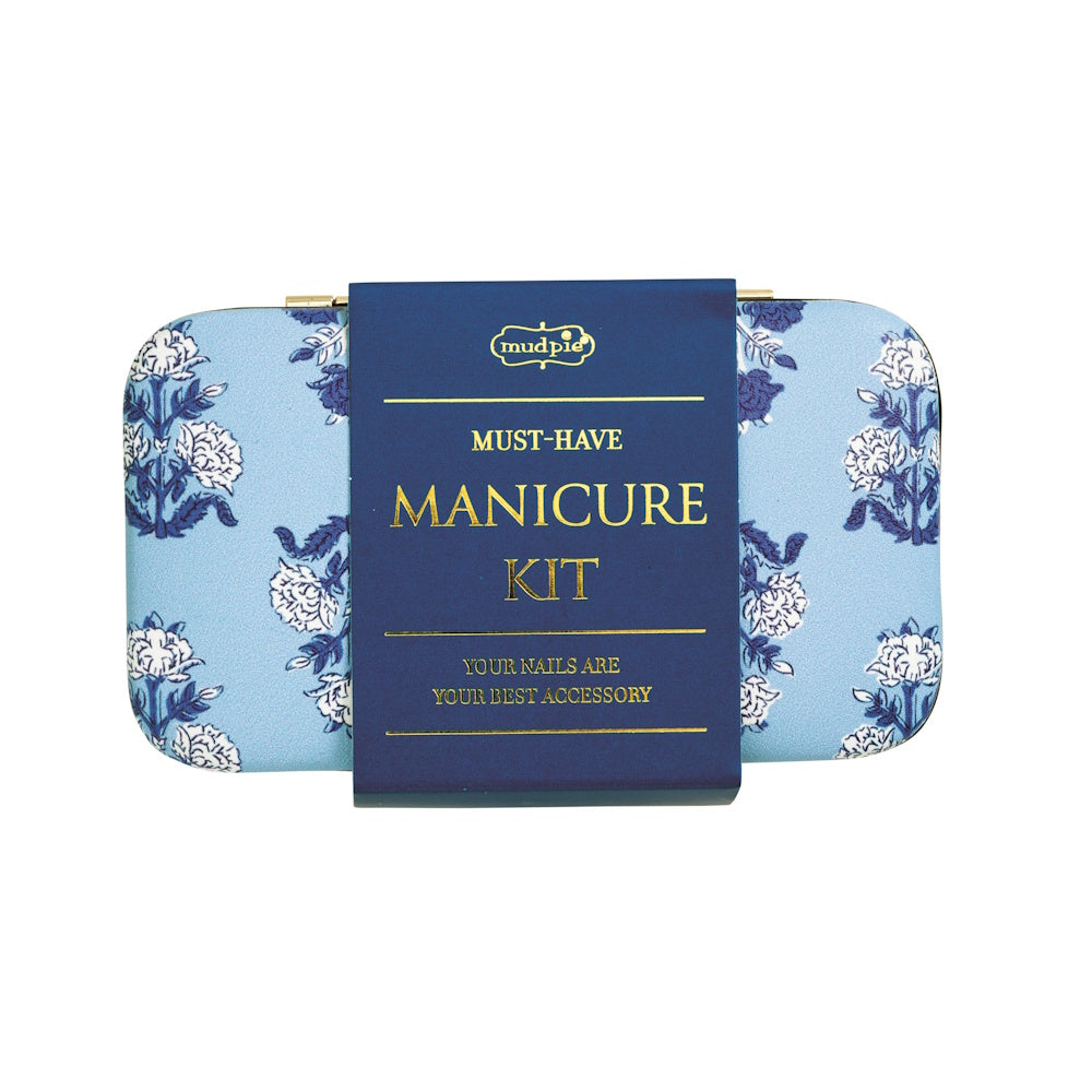 Mud Pie floral blue manicure kit case with a navy blue label reading "Must-Have Manicure Kit" in gold lettering.