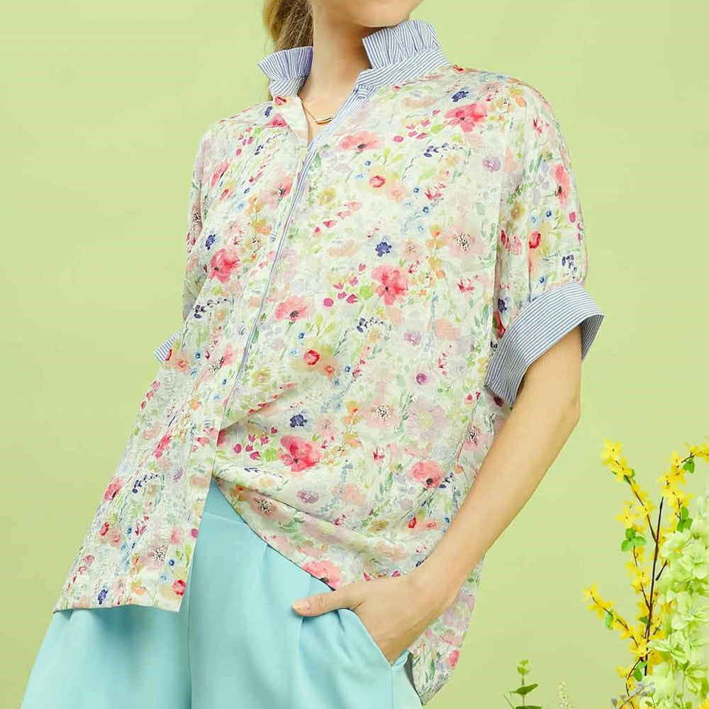 Floral jacquard button-down top with pink flowers, a ruffled striped collar, and cuffed sleeves. Chic spring blouse.