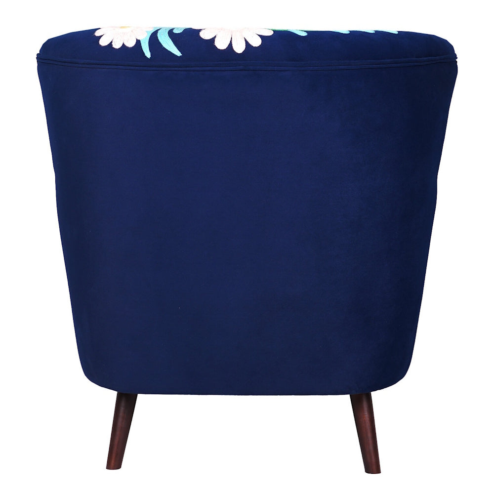 Rear view of navy blue upholstered accent chair with floral embroidery detail and tapered wooden legs.