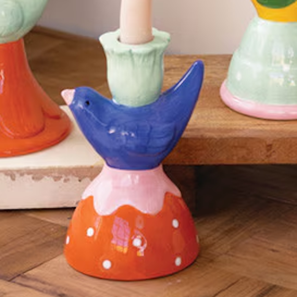 Colorful ceramic bird taper candle holder with a blue bird, mint green flower cup, and orange polka dot base.
