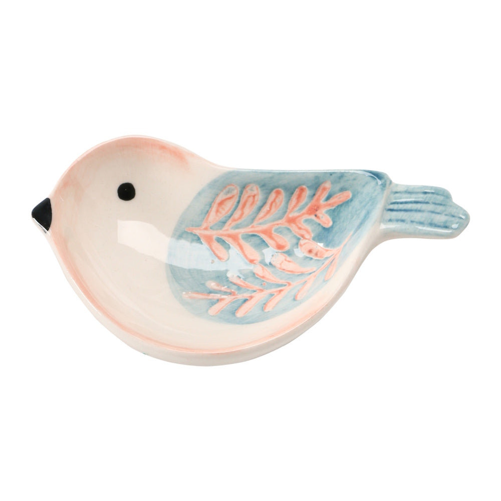 A hand-painted, bird-shaped stoneware dish in cream, light pink, and soft blue with a leafy wing pattern.