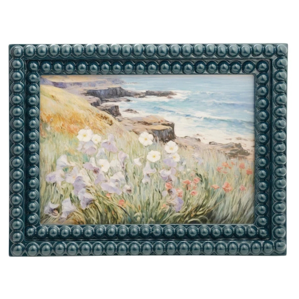 Teal bobbin resin photo frame featuring a coastal painting with wildflowers, cliffs, and ocean waves.