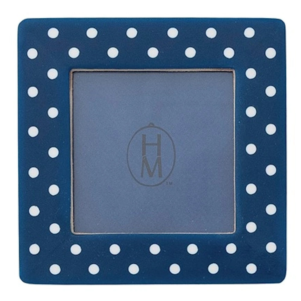 Square navy blue mini photo frame magnet with white polka dots around a square opening.