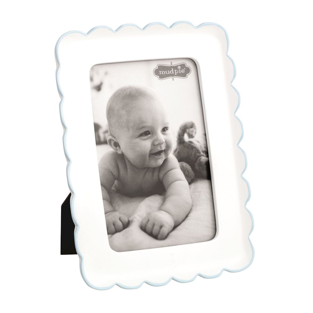 White Mud Pie scalloped resin baby picture frame with a light blue border trim on a black easel back.