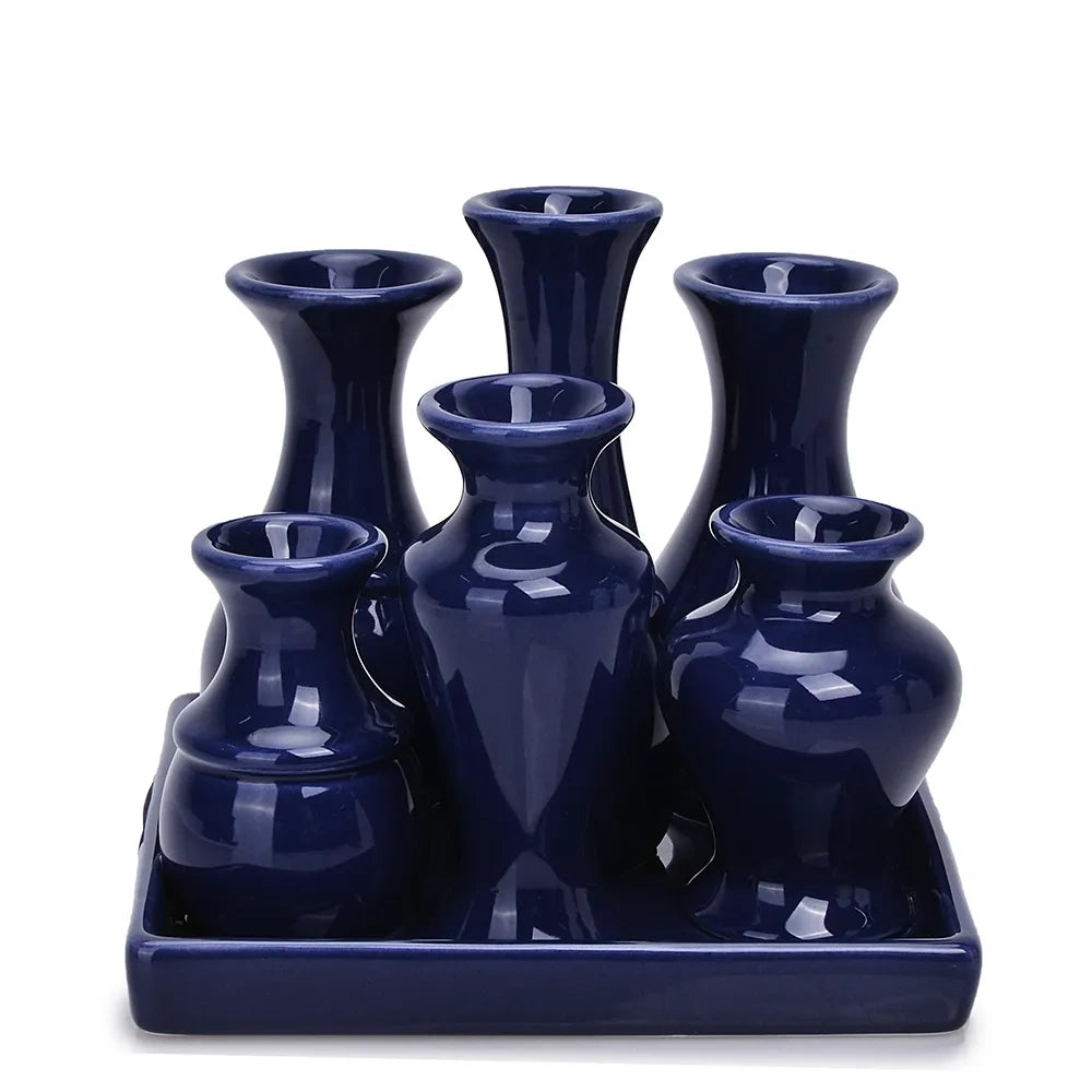 Blue ceramic bud vase set arranged on a matching tray from a front view.