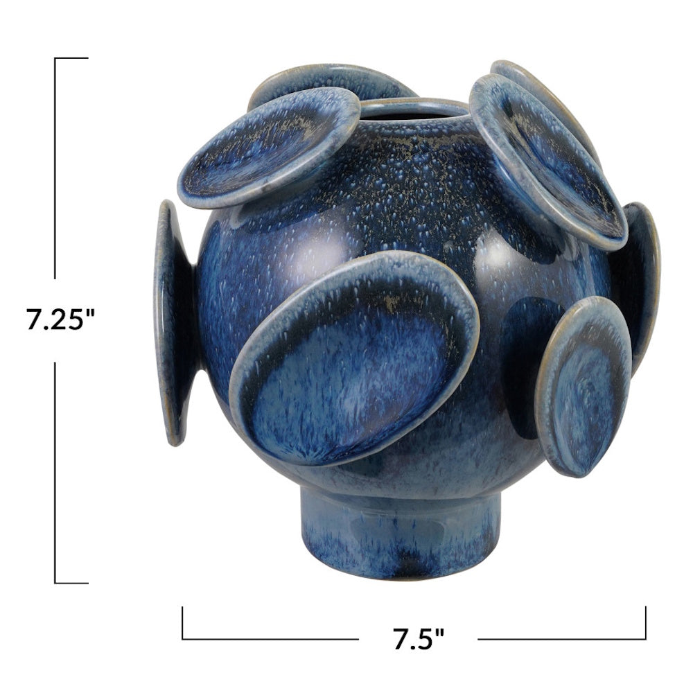 Blue stoneware footed vase with 3D disc details. Measures 7.25 inches high by 7.5 inches wide.