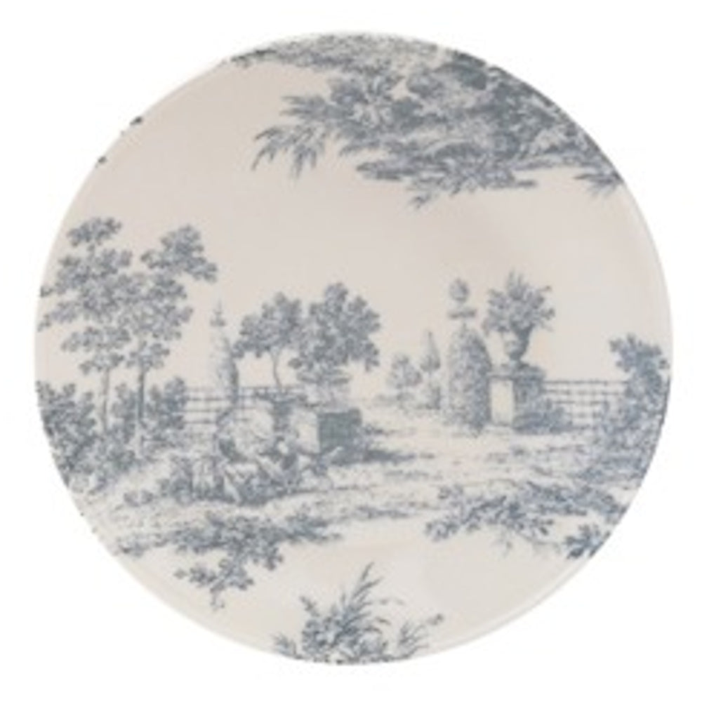 A round stoneware plate featuring a blue toile pattern of a pastoral landscape with trees and garden pedestals.