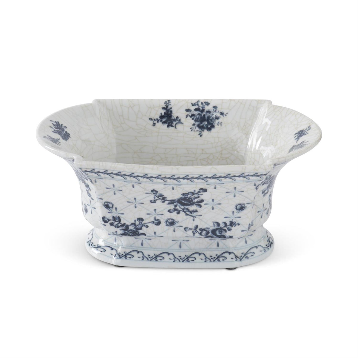 Antique blue and white floral porcelain bowl with crackle glaze finish and flared rim on white background.