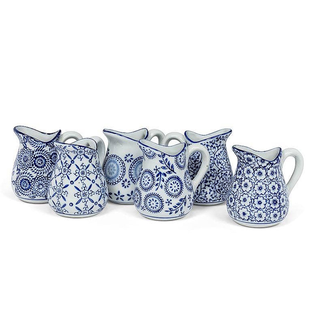 Set of six assorted mini ceramic pitchers featuring unique blue and white floral and geometric patterns.
