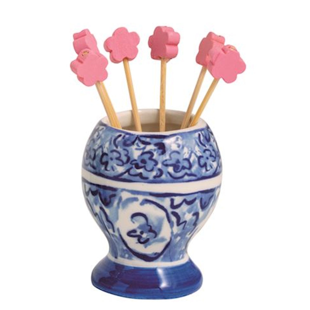 Blue and white ceramic toothpick holder with pink flower-topped picks.