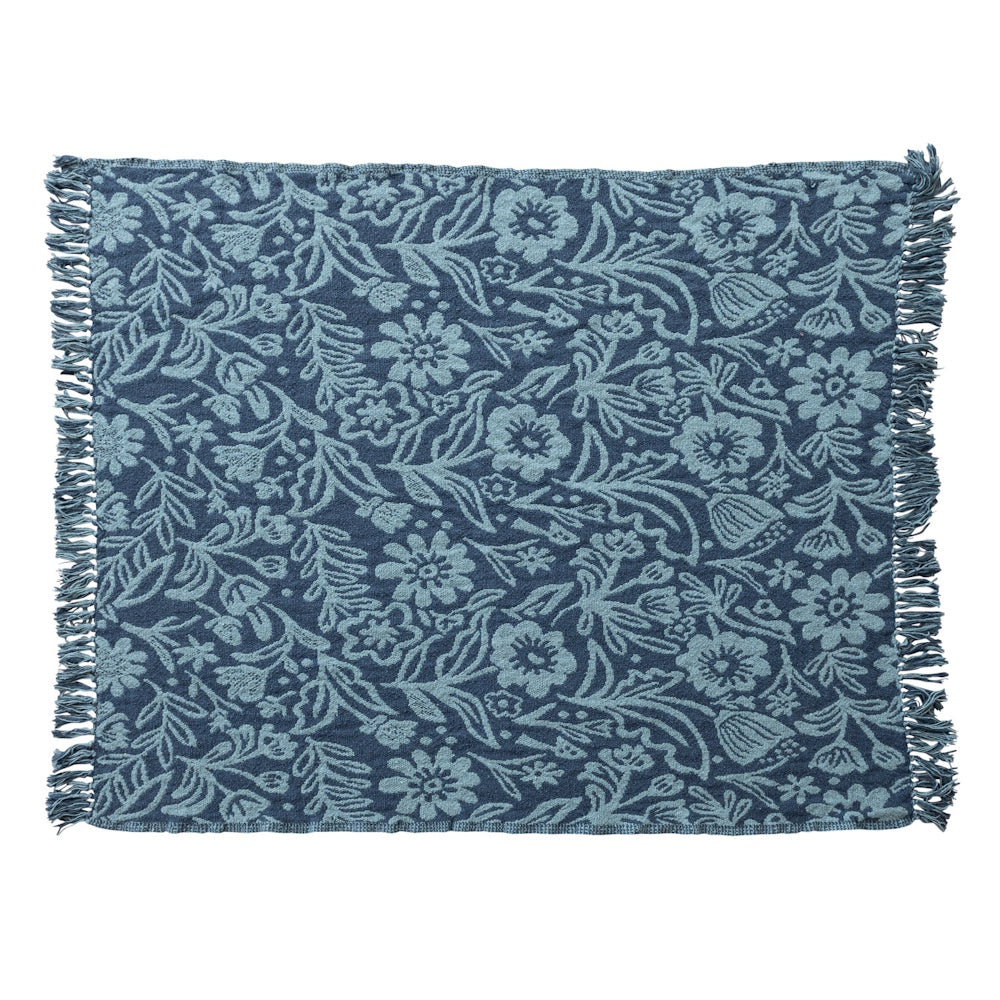 Woven recycled cotton blend jacquard throw in blue with a floral pattern and fringed edges.