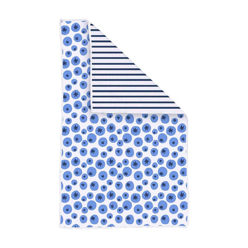 A kitchen tea towel with a blue blueberry pattern, folded to show a navy and white striped reverse side.