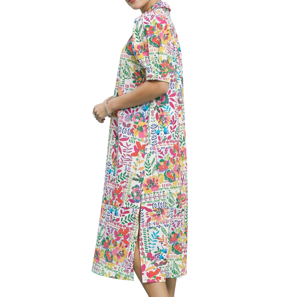 Side view of a person wearing a vibrant, multicolored floral print midi dress with short sleeves.