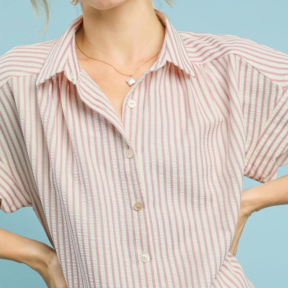Blush and white striped button-down shirt with a collar and short sleeves, featuring a subtle seersucker texture.