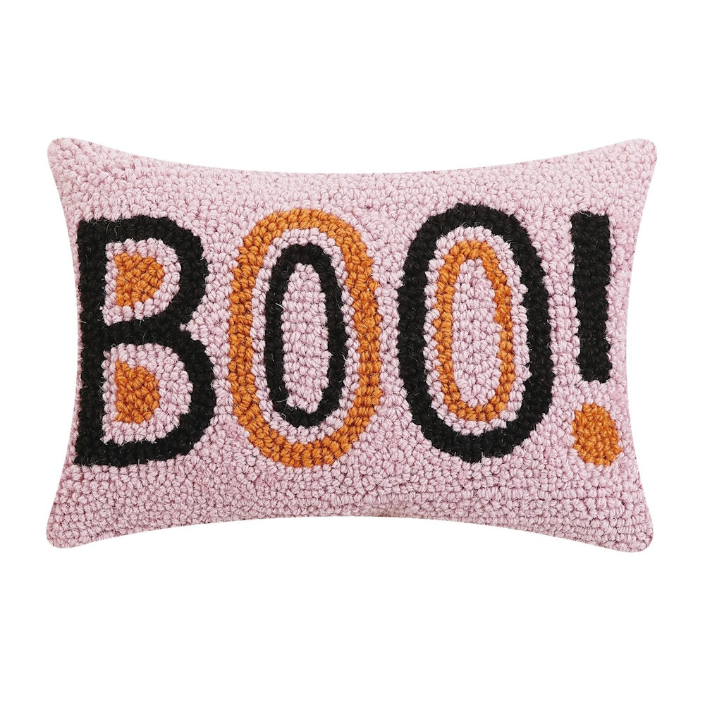 Pink hooked lumbar pillow featuring "BOO!" in black and orange lettering.