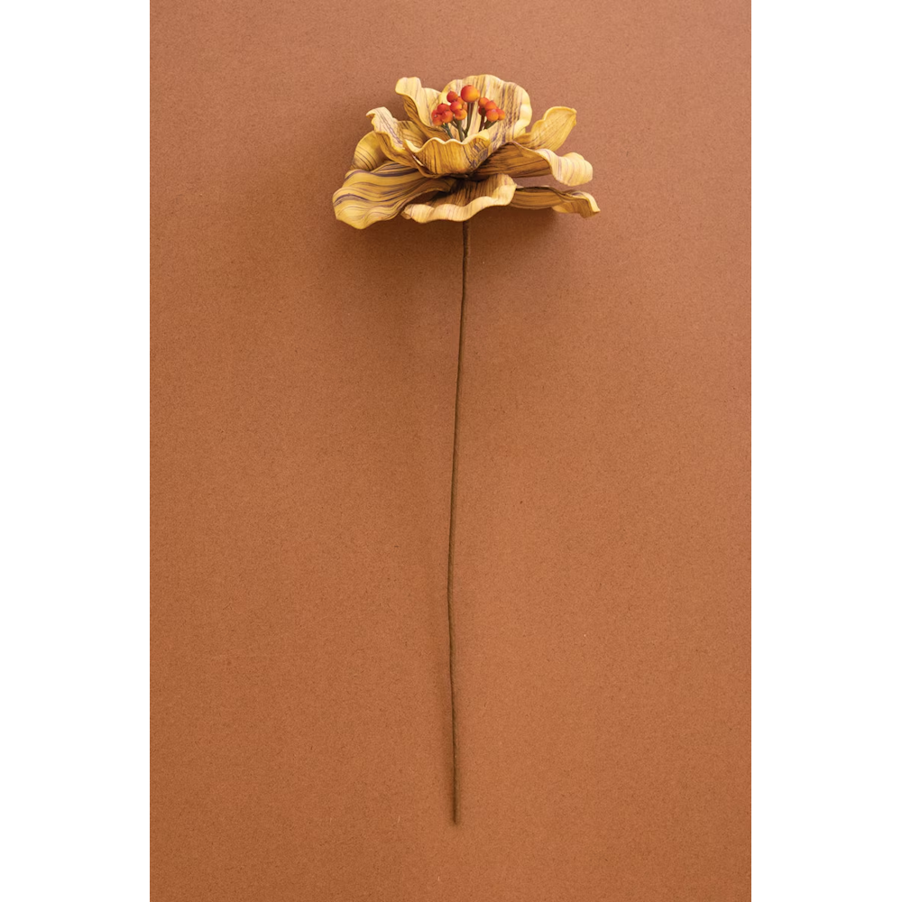 Single yellow artificial flower stem with orange-red berries on a warm brown background.