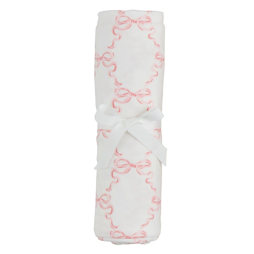 Pink bow print soft knit baby swaddle blanket rolled with a white decorative ribbon tie.