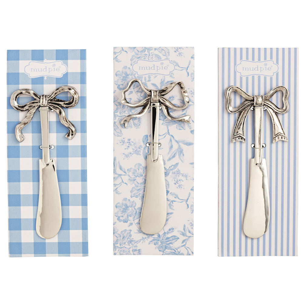 Silver bow cheese spreaders on blue and white patterned gift cards, perfect for hosting and kitchen serving.