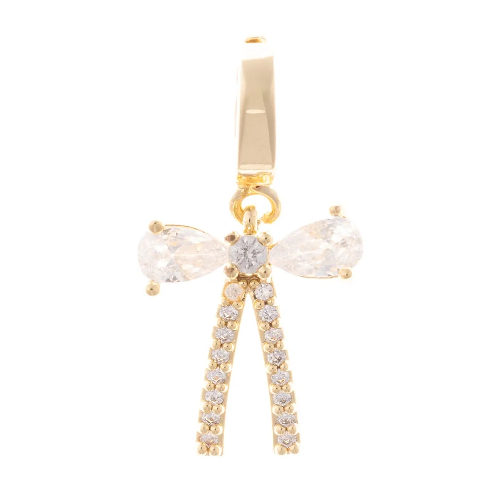 Gold bow pendant charm with pear-cut crystal loops and pave-set ribbon tails on a white background.