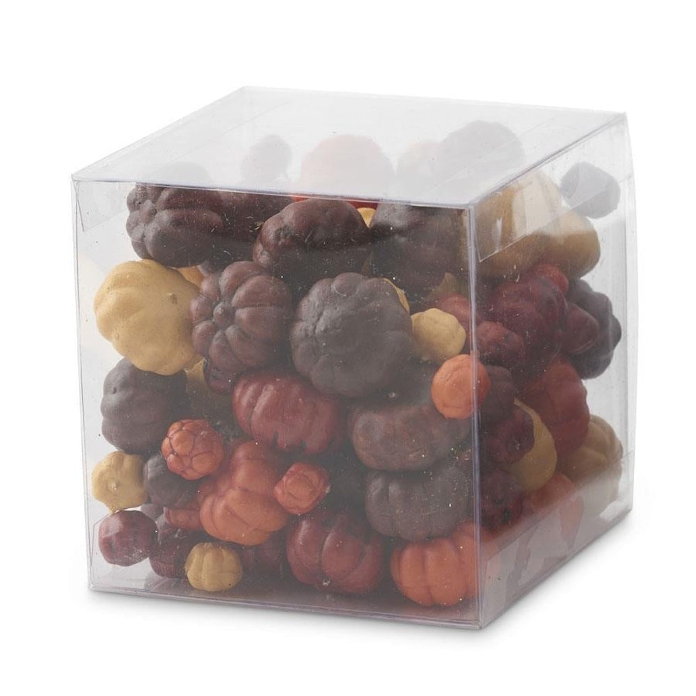 Clear cube box filled with assorted mini decorative pumpkins in autumn shades of orange, yellow, and brown.