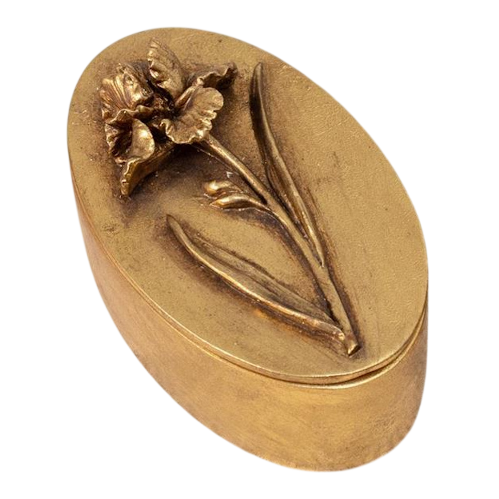 Antique oval brass trinket box with a high-relief iris flower engraving on the lid, vintage matte gold finish.