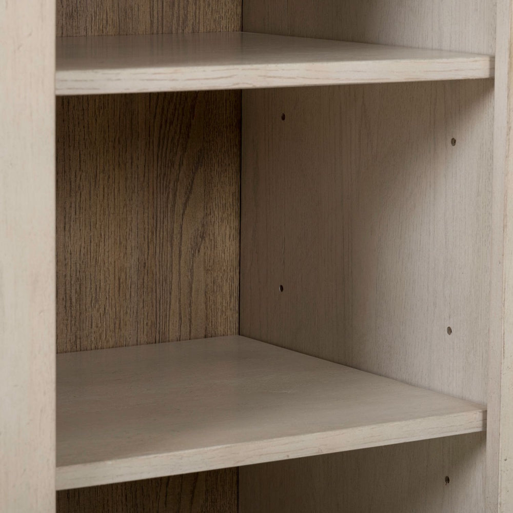 Close-up of adjustable shelves inside a white wood breakfront accent cabinet.