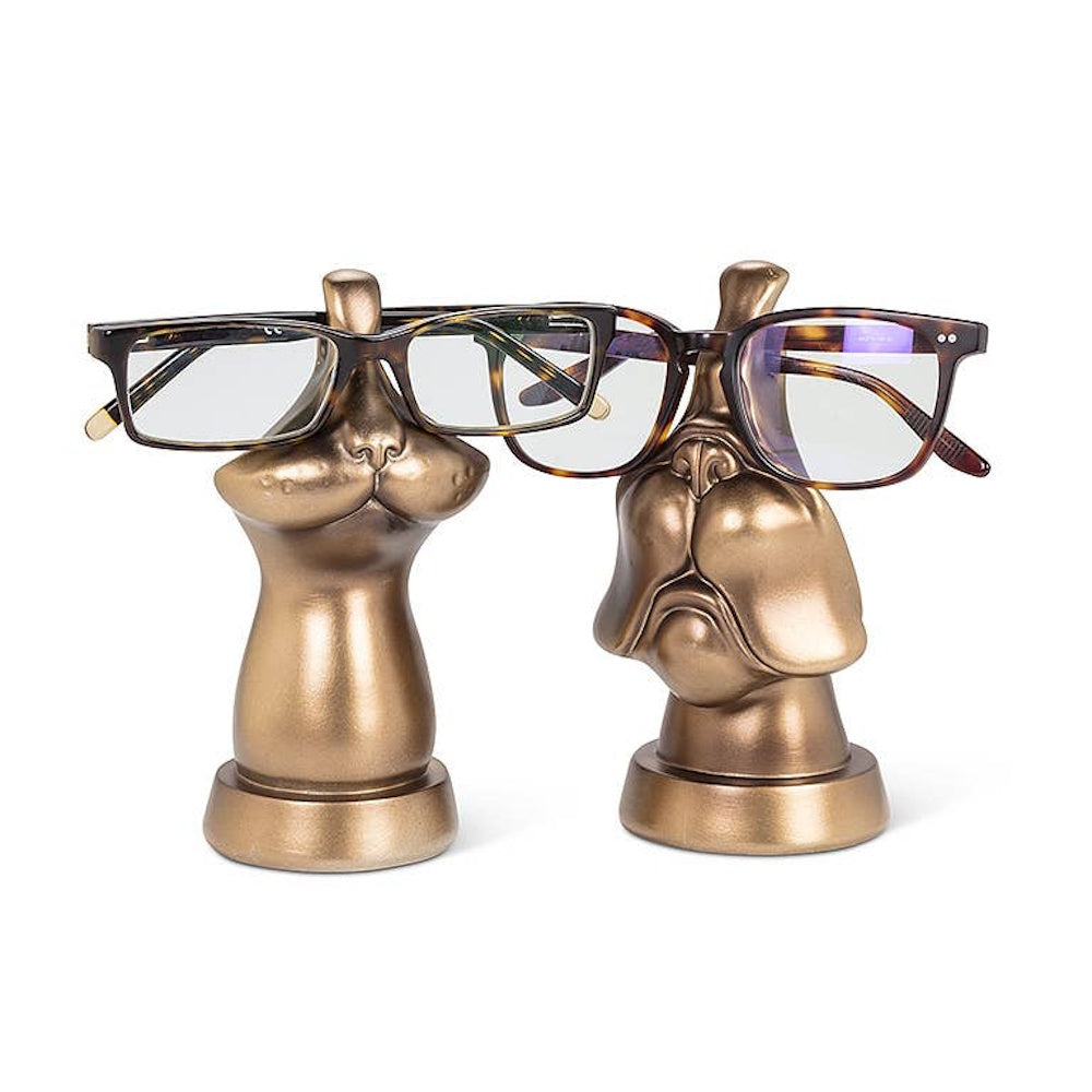 Two bronze animal face eyeglass holder stands displaying tortoiseshell glasses.