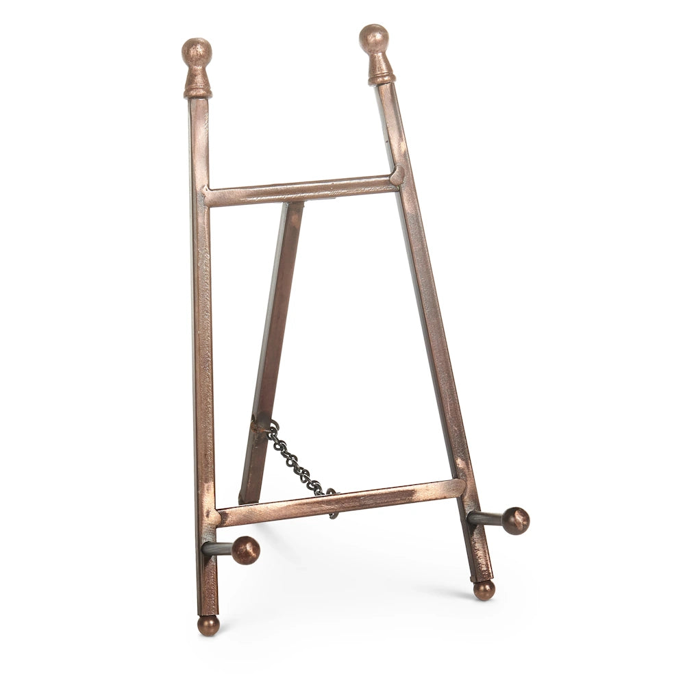 Bronze metal mini easel with a tripod back, chain support, and decorative ball finials on a white background.