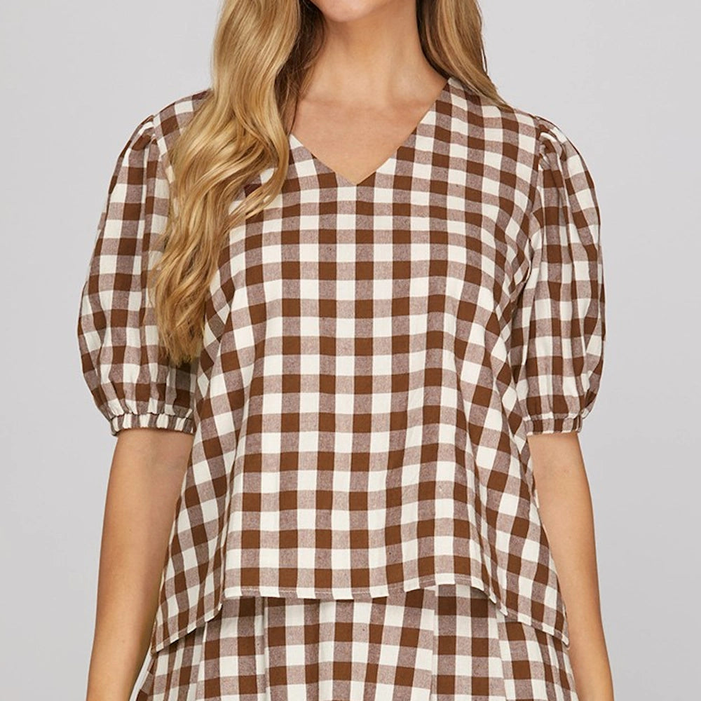 Brown and white gingham checked V-neck top with short puff sleeves.
