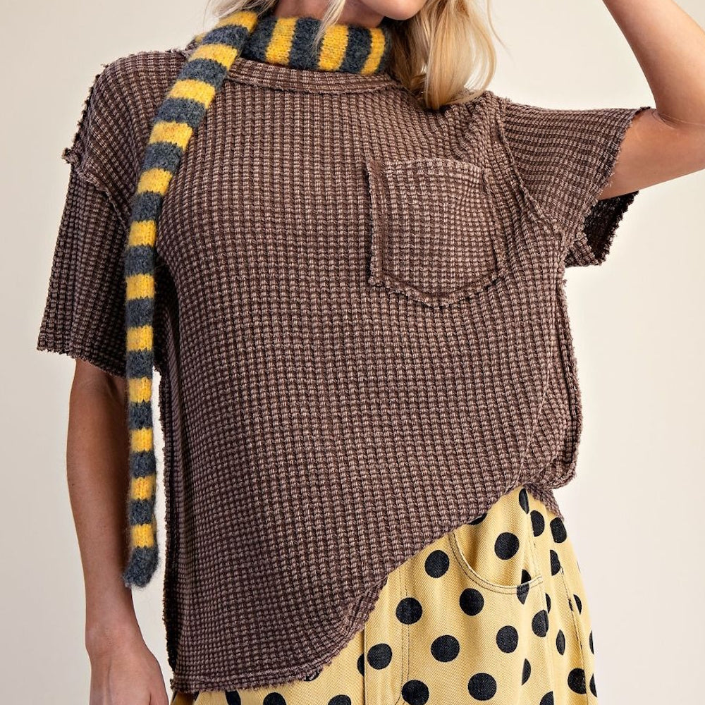 Brown short-sleeve mineral-washed waffle knit top with a chest pocket and raw-edge seam details.