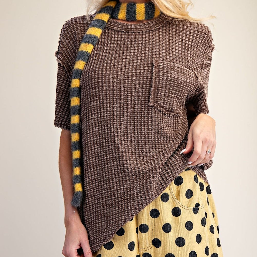 Front view close-up of brown short-sleeve mineral-washed waffle knit top with pocket detail.