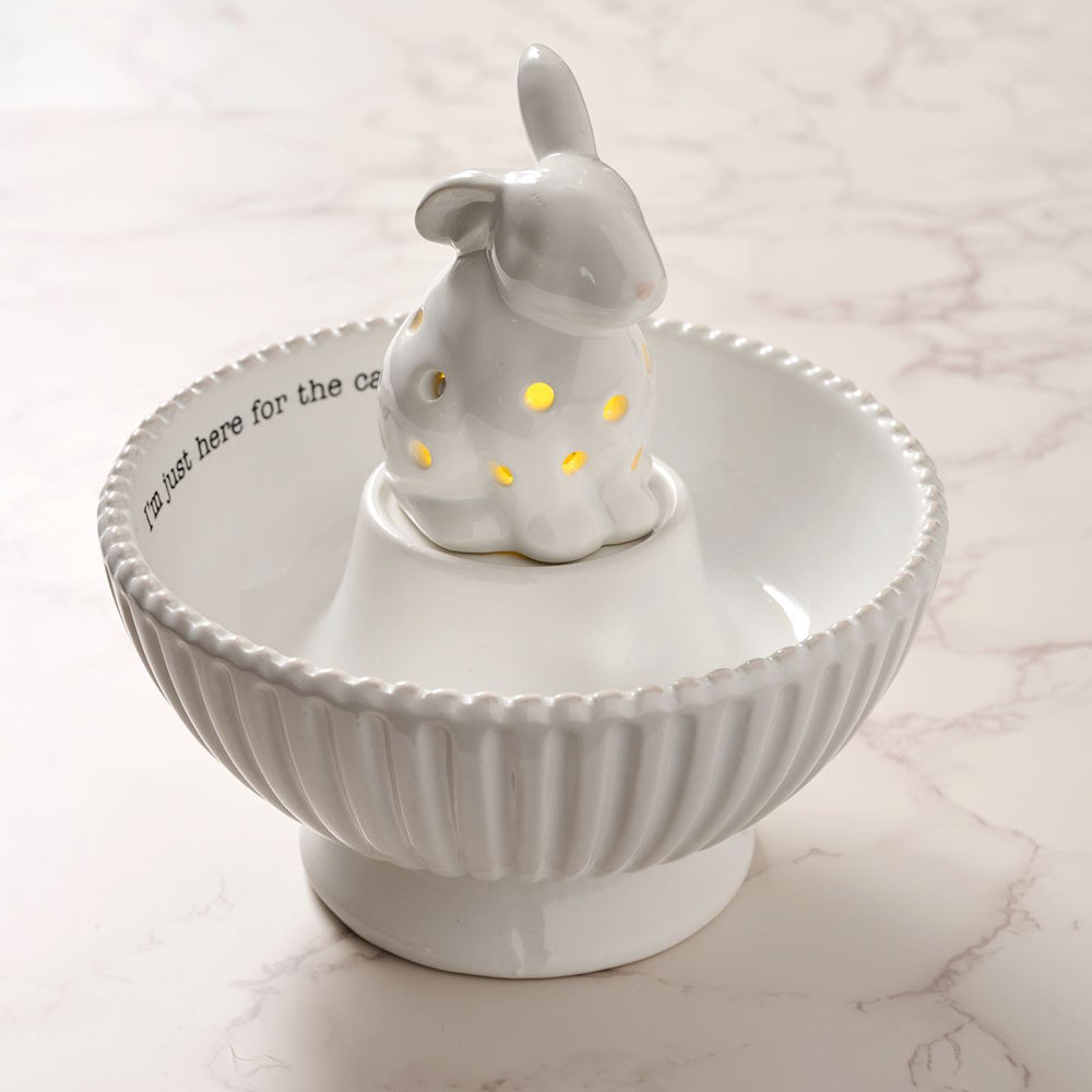 White ceramic bunny light-up candy bowl with "I'm just here for the candy" text on a marble surface.
