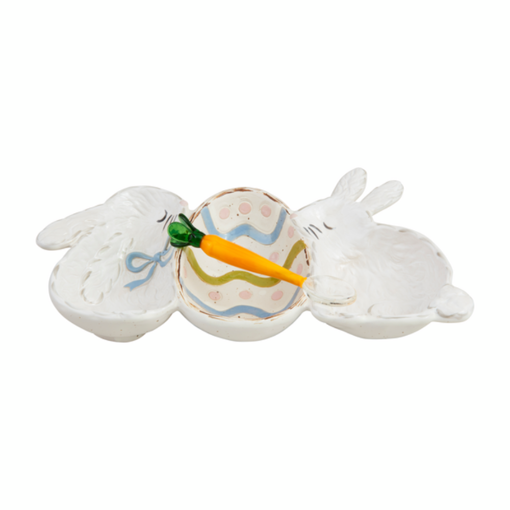 White ceramic Easter serving dish with two bunnies, a painted egg center, and a carrot-shaped spoon.