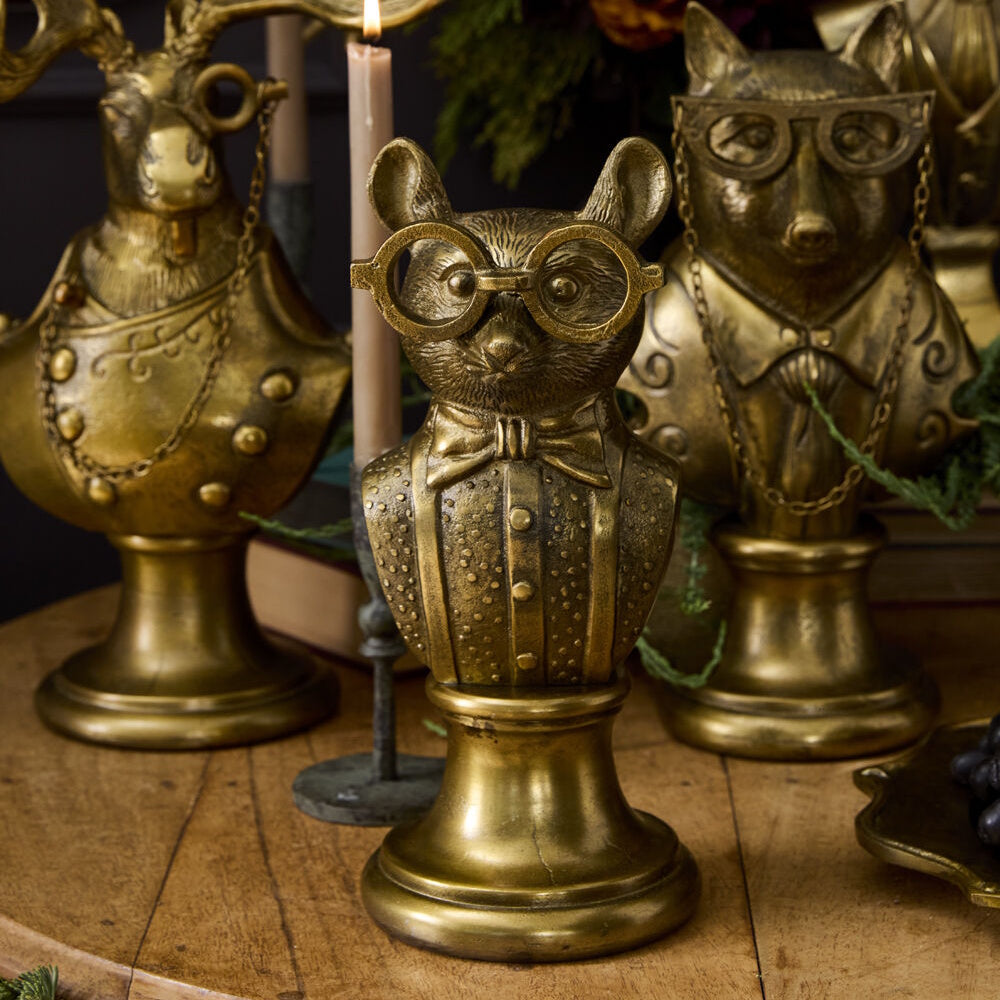 Gold resin mouse bust figurine wearing glasses and a bow tie in a front lifestyle view.