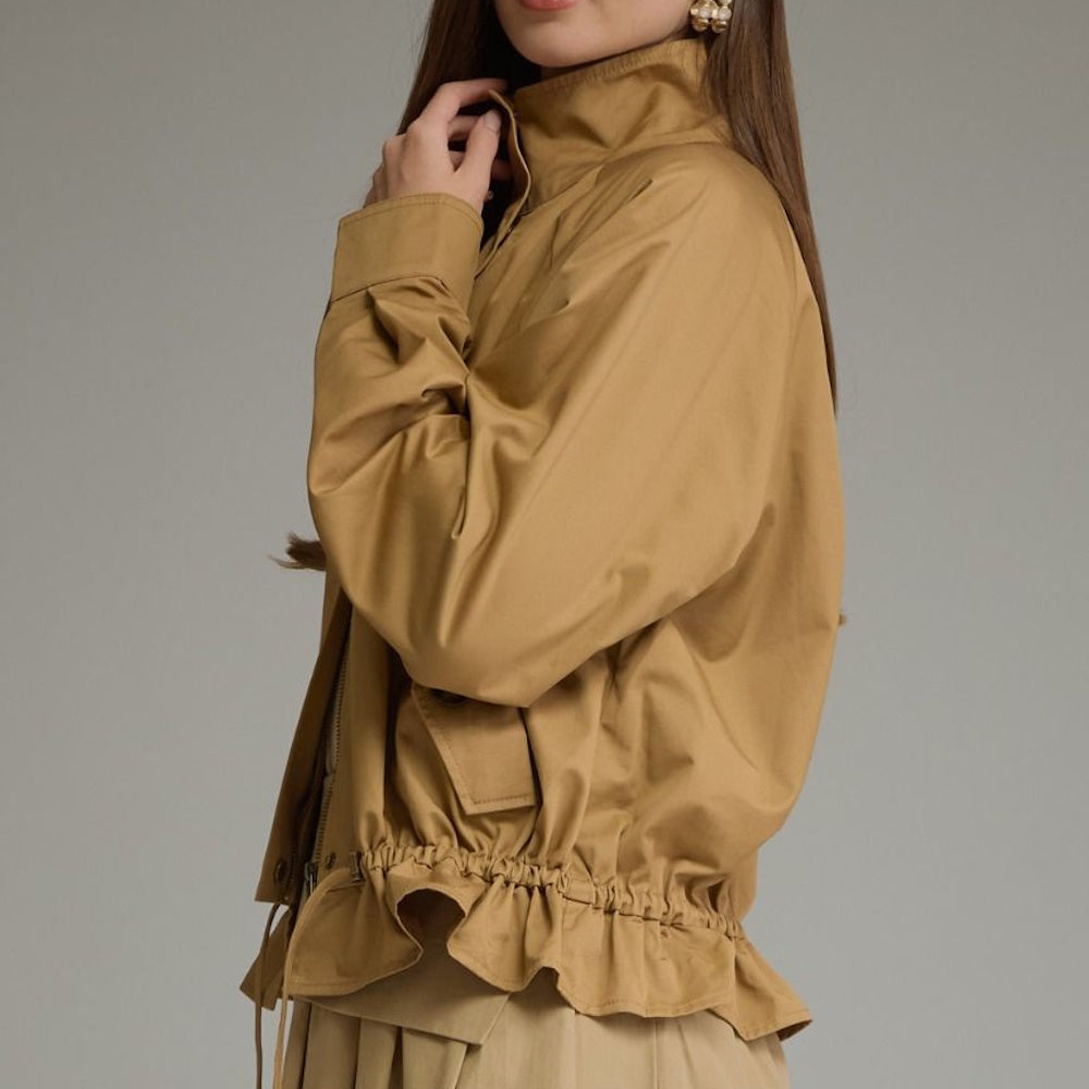 Side view of a camel full-zip jacket featuring a high collar and cinched ruffle hem.