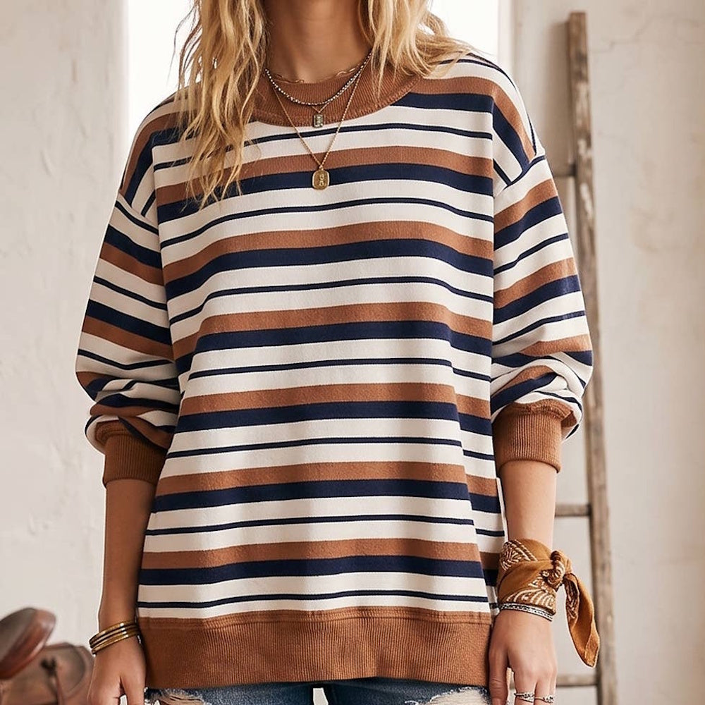 Oversized French terry sweatshirt with horizontal camel brown, navy, and cream stripes and ribbed trim.