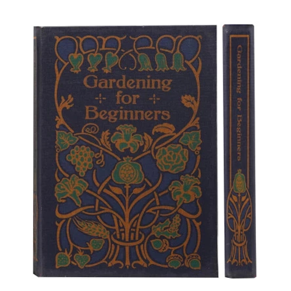 Vintage "Gardening for Beginners" notebook with a navy blue canvas cover and ornate gold floral illustrations.