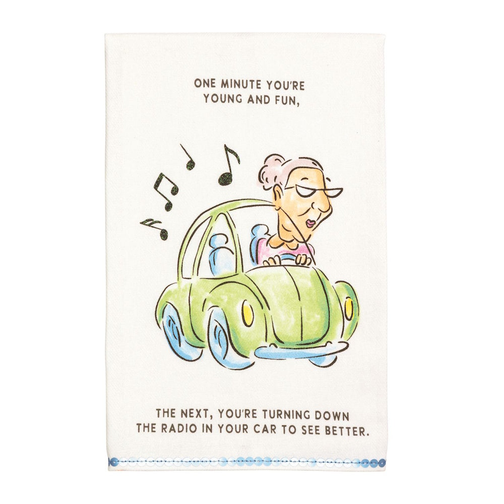 Funny kitchen towel featuring an older woman driving a green car and humor text about getting older.