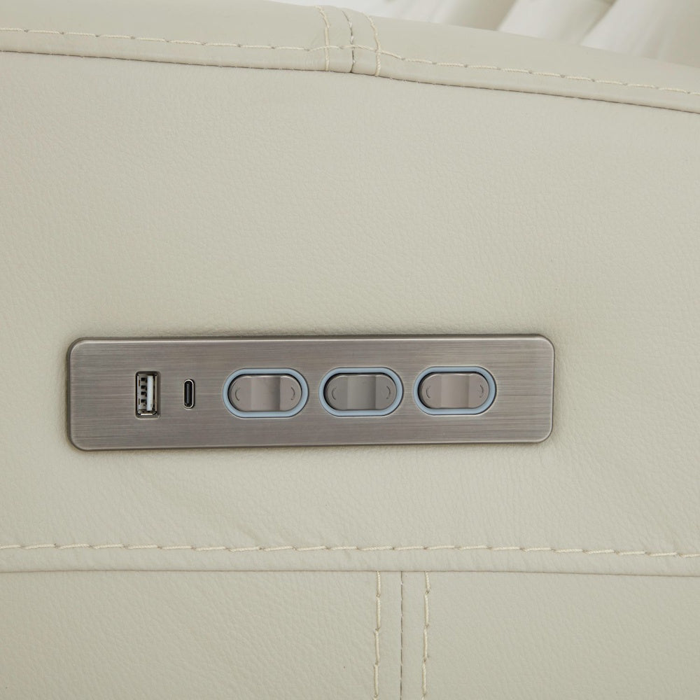 Close up of power recliner control panel with USB and USB C charging ports integrated into cream leather armrest.