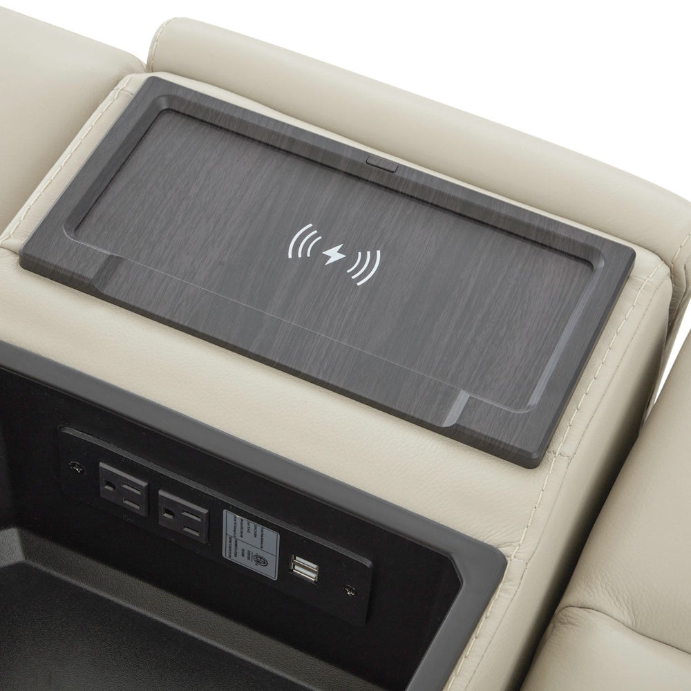 Close up of sofa storage console with wireless charging pad, power outlets and USB charging ports.