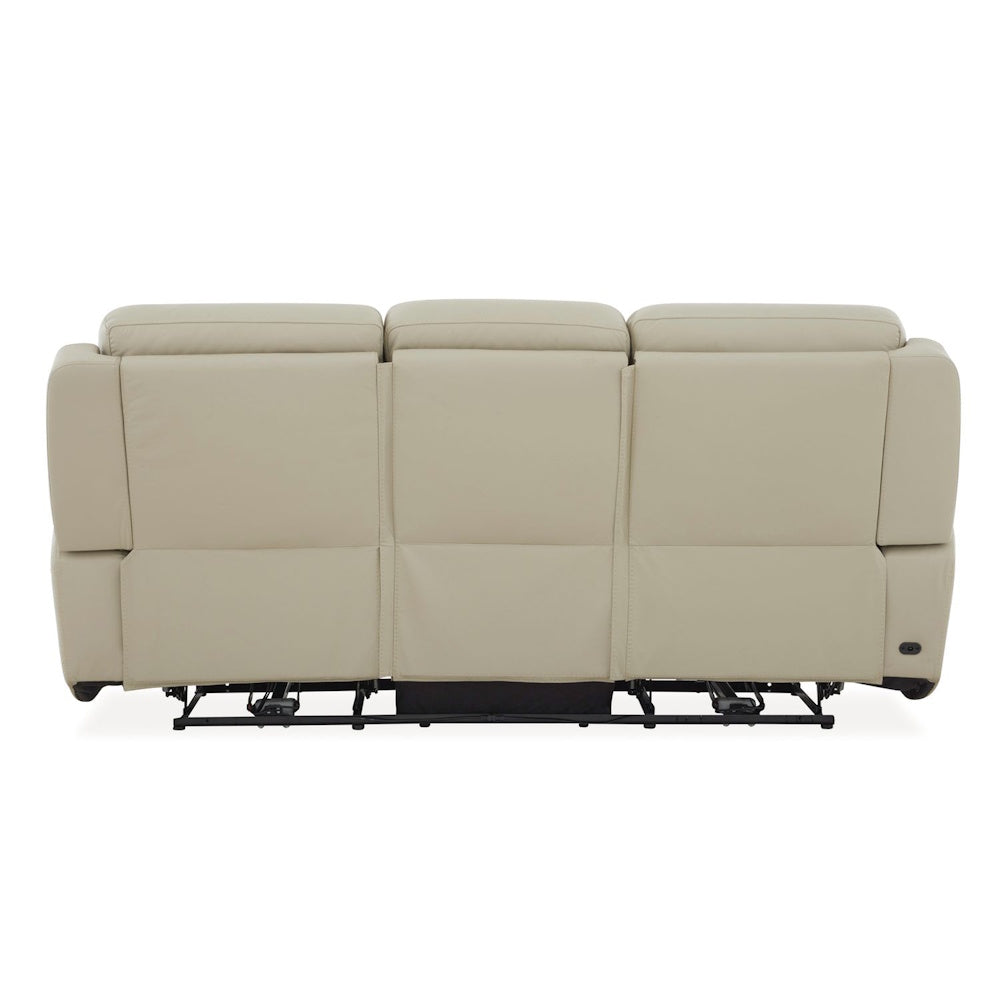 Rear view of cream leather power reclining sofa with three seat backs and exposed reclining mechanism base.