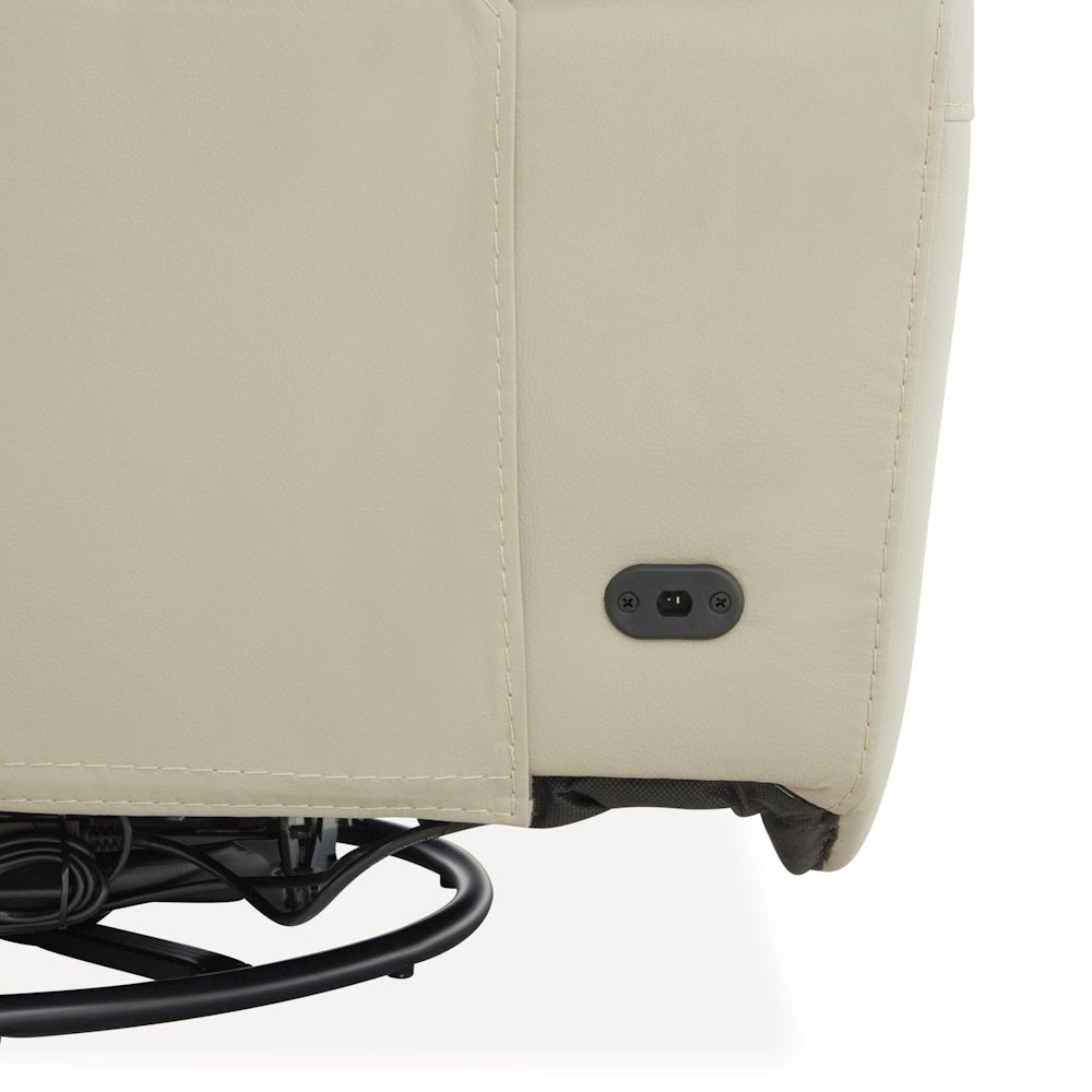 Close up of cream leather reclining sofa base with power connection port and sturdy metal support frame.